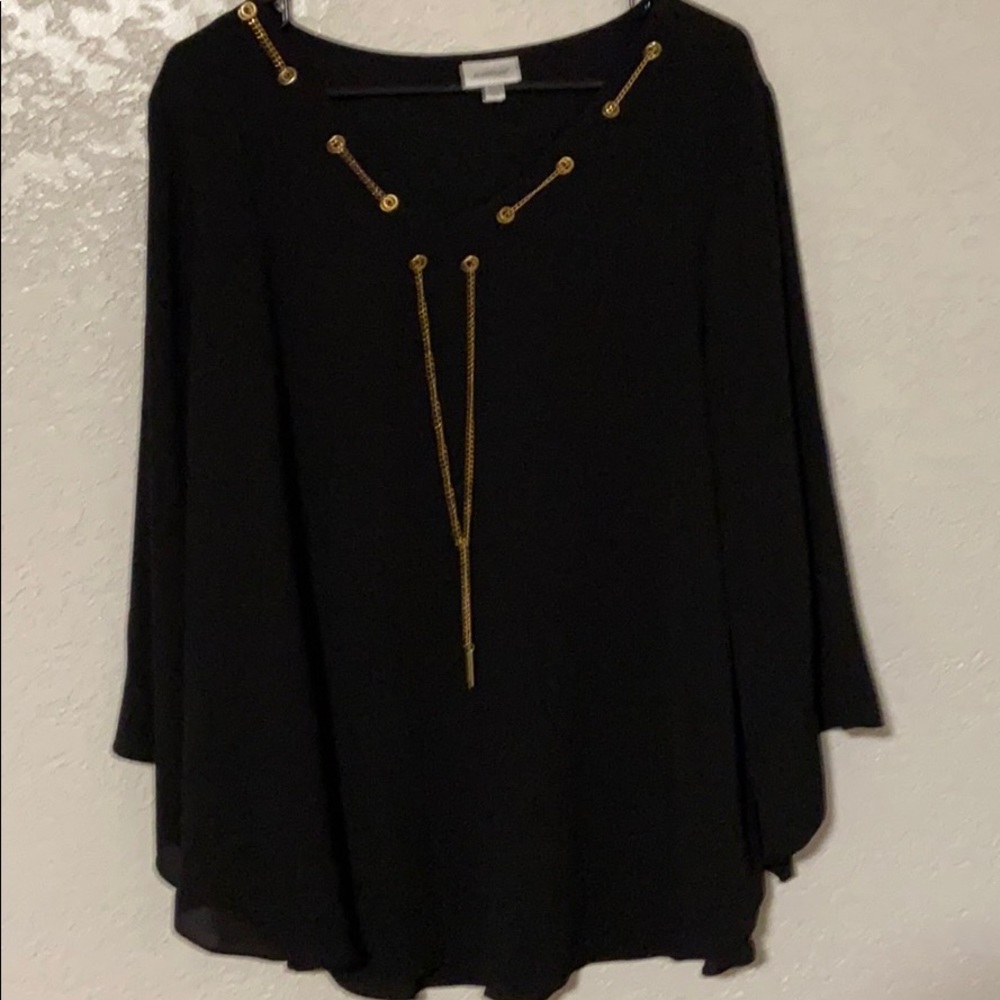 Black shirt with attached gold necklace.